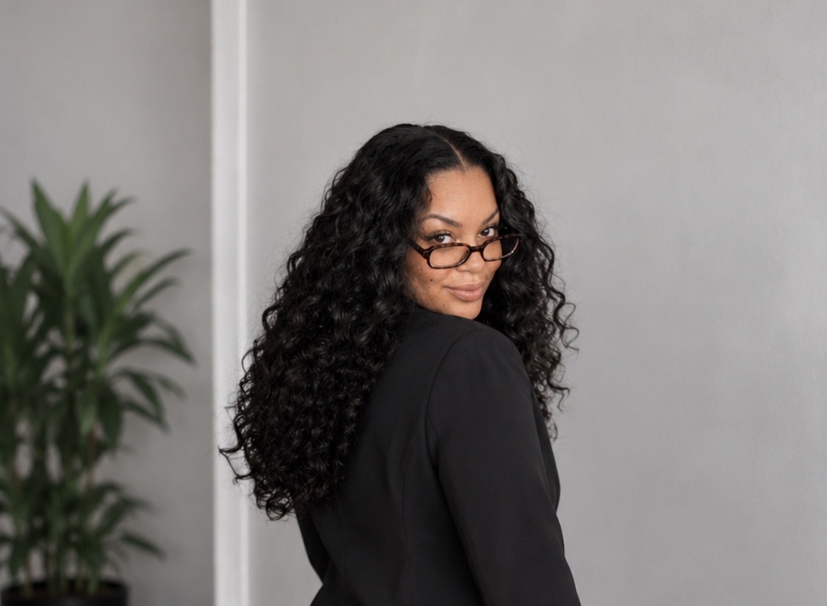 Brittney S. Austin — portrait in black blazer and glasses